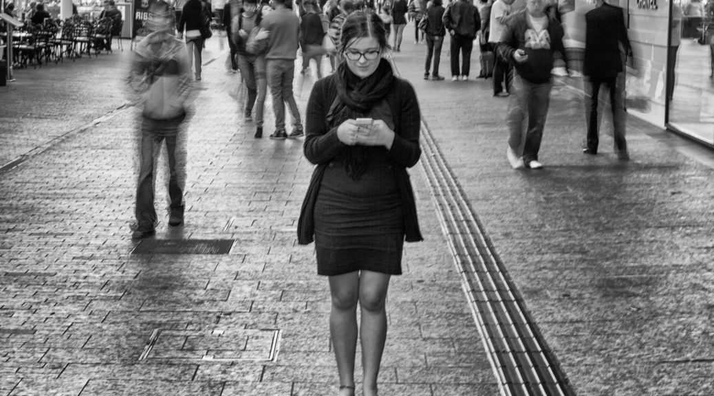 black and white photo of a single woman on her phone